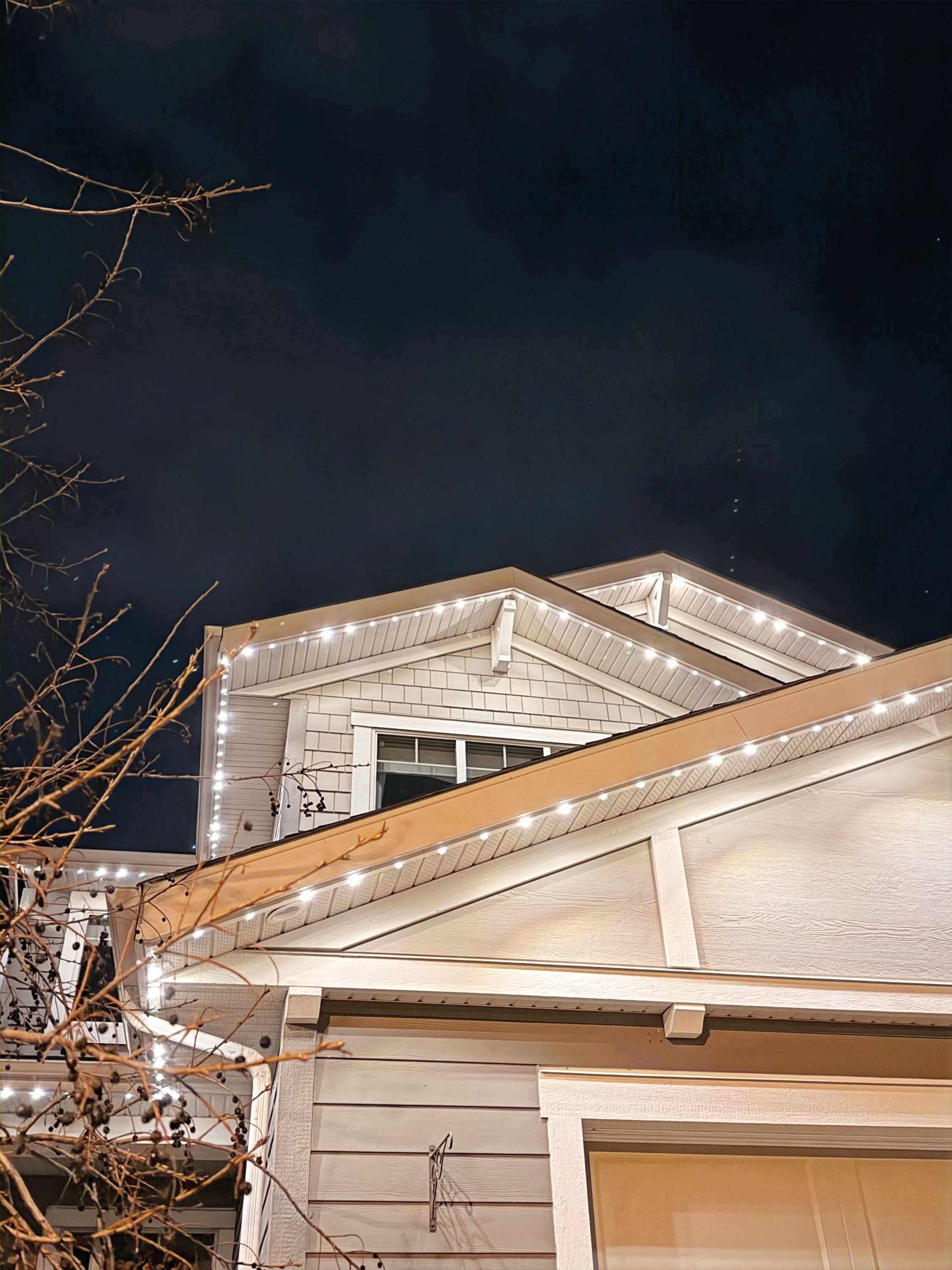 Permanent accent lighting casting an elegant glow across a Calgary residential exterior
